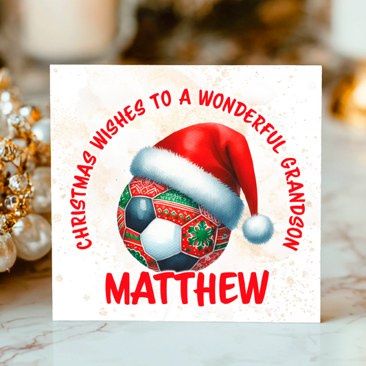 Christmas card with a football with festive patterns on it wearing a Christmas hat 