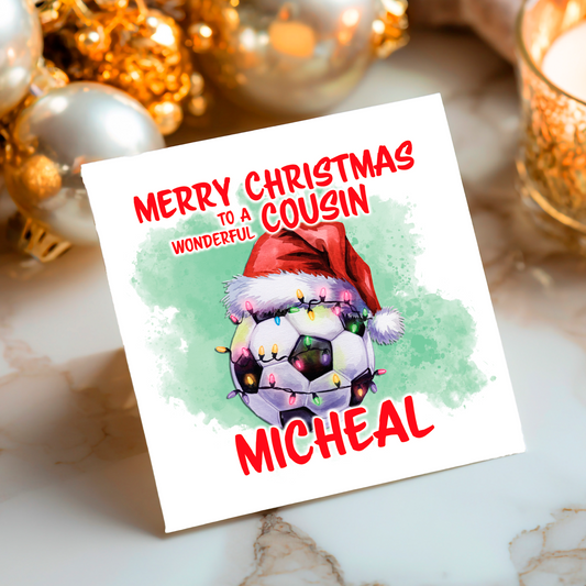 Christmas card with image of a football wrapped in Christmas light and wearing a Santa hat set on a festive background