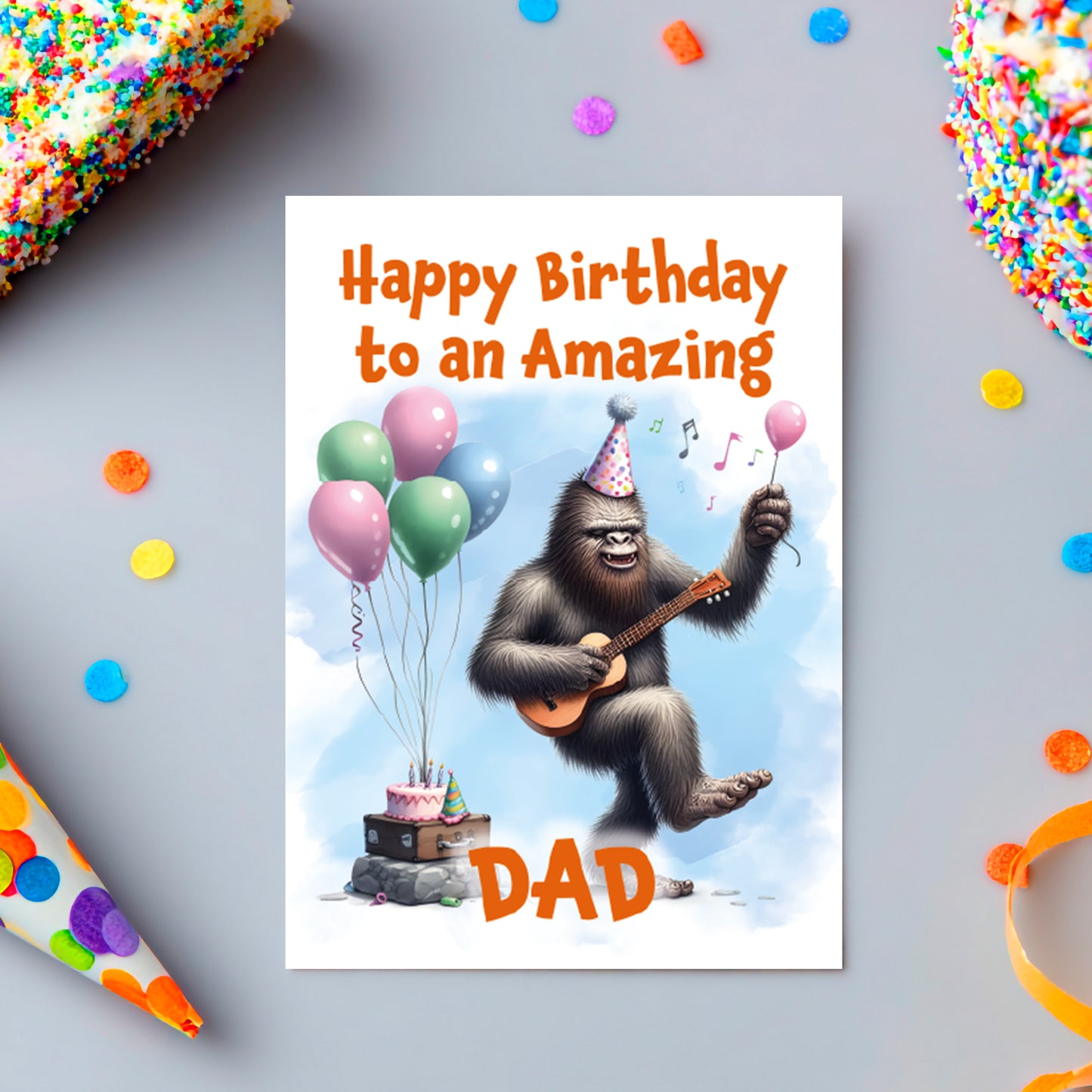 Birthday card with a gorilla playing guitar and balloons, text 'Happy Birthday to an Amazing Dad' on a colorful background.