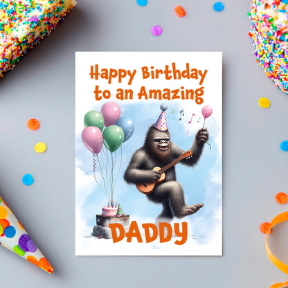 Birthday card with a gorilla playing guitar and balloons, text 'Happy Birthday to an Amazing Daddy' on a colorful background.