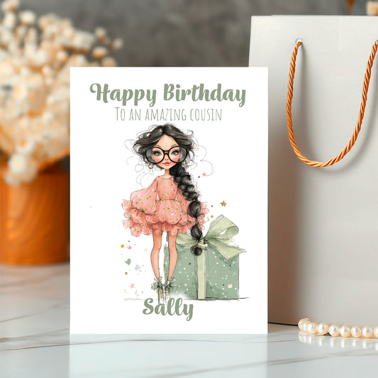 Birthday card with illustration of a girl in a pink dress and glasses, holding a gift, with 'Happy Birthday to an amazing cousin Sally' text.