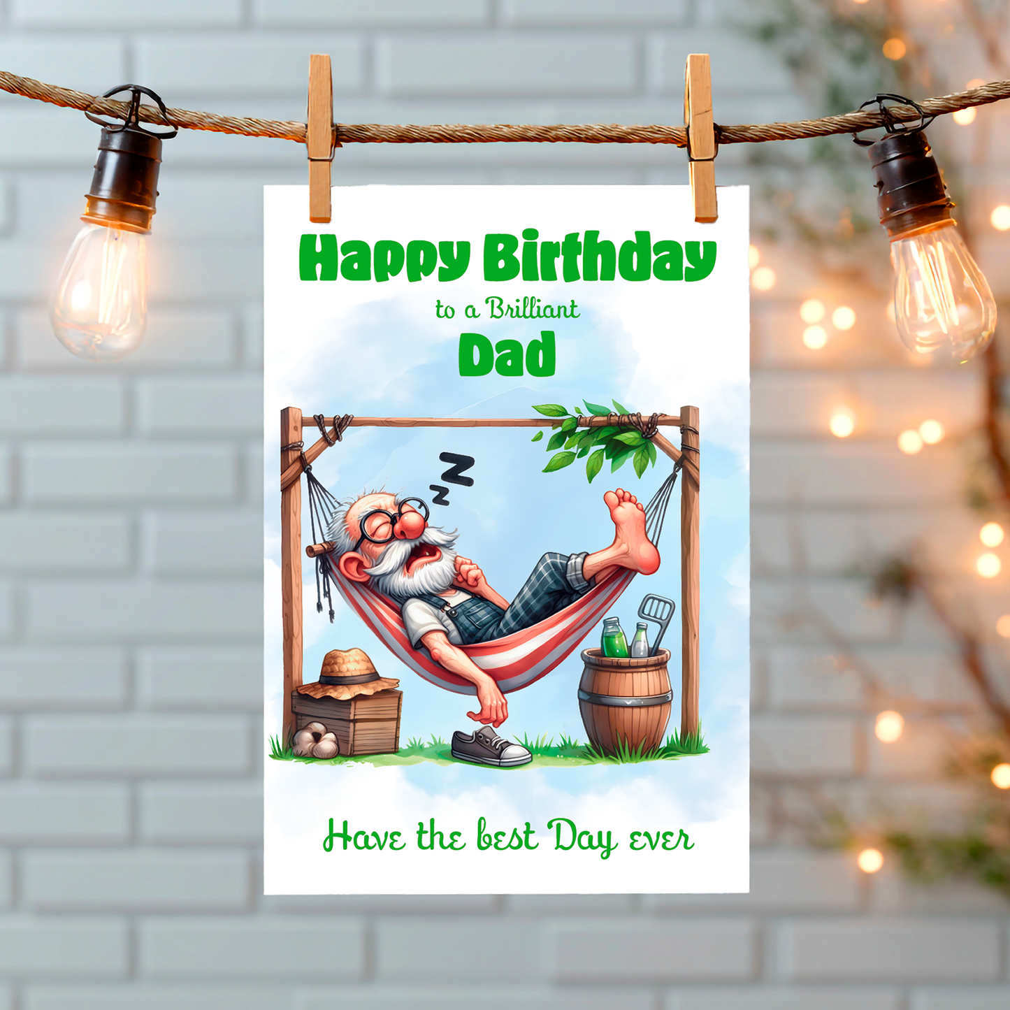 Birthday card for a dad with a cartoon character relaxing in a hammock, hanging on a string with lights. Can Be personalised for any male relation or a friend