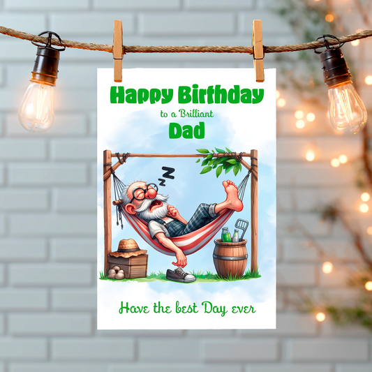 Birthday card for a dad with a cartoon character relaxing in a hammock, hanging on a string with lights. Can Be personalised for any male relation or a friend
