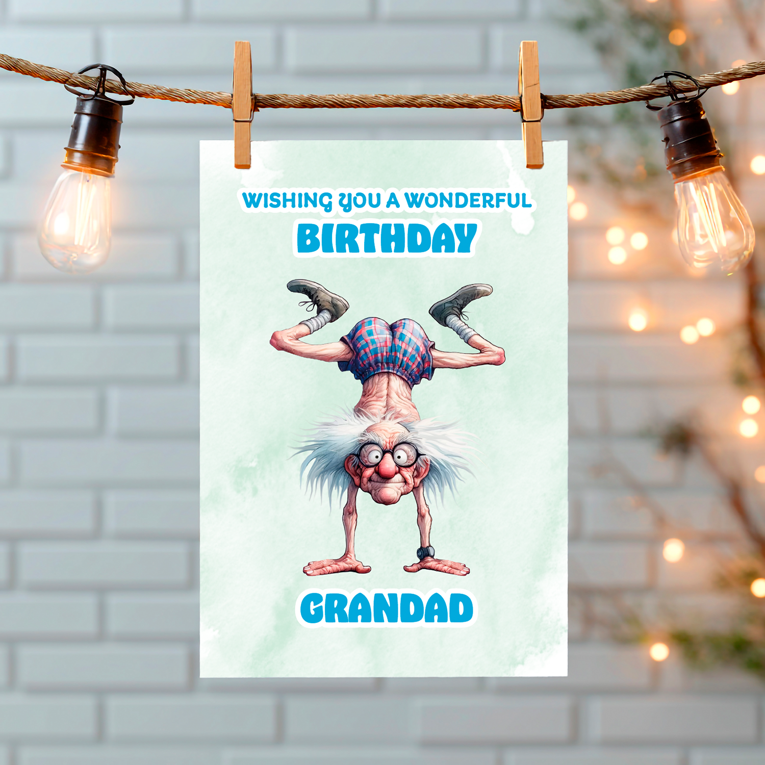 Birthday card for grandad with cartoon character hanging upside down, against a light brick wall background. Can Be personalised for any male relation or a friend