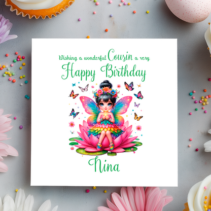 Birthday card with a colorful fairy on a pink flower, surrounded by butterflies and flowers on a gray background.