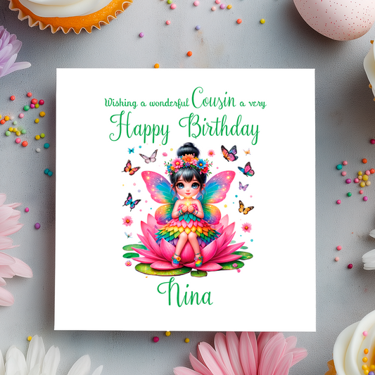 Birthday card with a colorful fairy on a pink flower, surrounded by butterflies and flowers on a gray background.