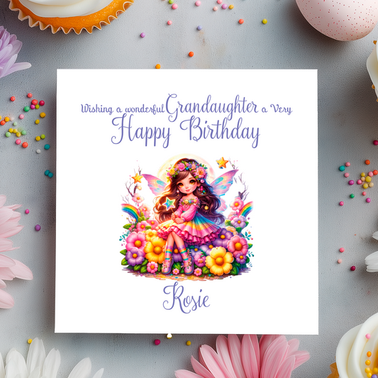 Birthday card with a fairy illustration and colorful text on a decorative background with flowers and candies.