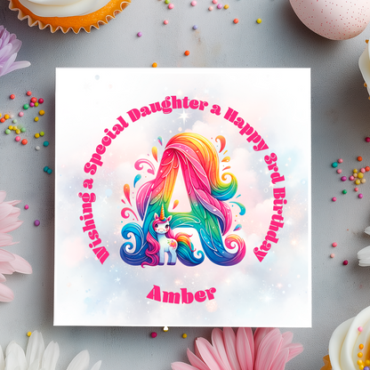 Colorful birthday card with unicorn design and text on a gray background with flowers and sprinkles.