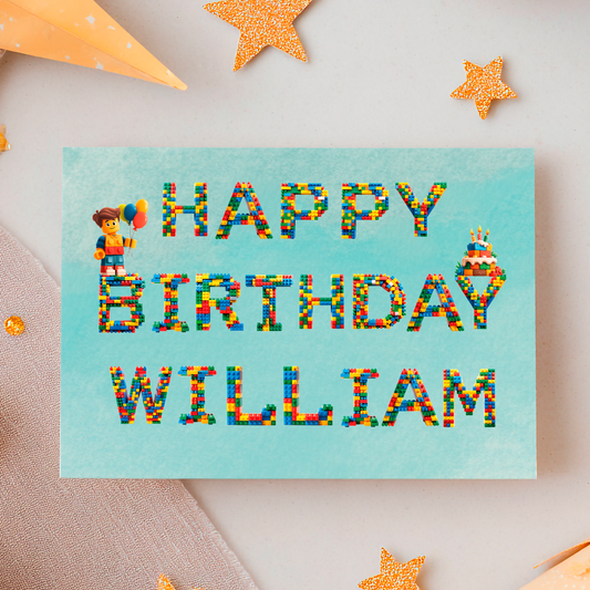 Birthday Card  with Leggo letters that spell out  'Happy Birthday (Name)  with a lego character and birthday cake. Can be personalised for any name 