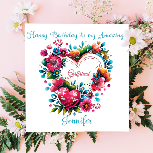 Greeting card with floral design and 'Happy Birthday to my Amazing Girlfriend' text on a pink floral background.