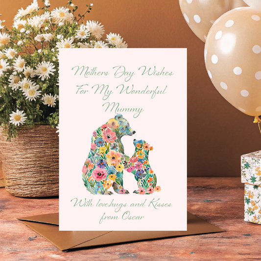 Greeting card with floral bear design and text, placed on a wooden surface with flowers and balloons. Can be personalised for Mum, Mummy, Step Mum,Step Mummy,Grandma or Nanna and child/childrens names added