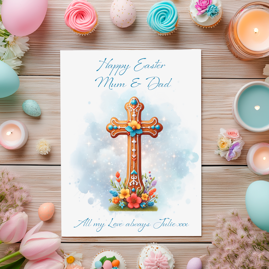 Easter card with cross design surrounded by Easter decorations on a wooden surface. Can be personalised with name and relation