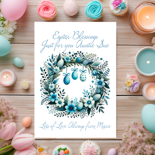 Easter-themed card with floral wreath design surrounded by Easter decorations on a wooden surface. Can be personalised for name and relation