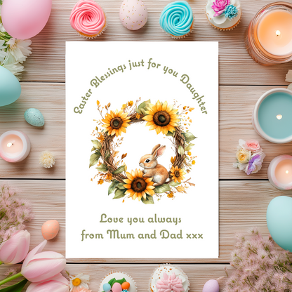 Easter-themed card with bunny and sunflower design, surrounded by Easter decorations on a wooden surface. Can be personalised for name and relation