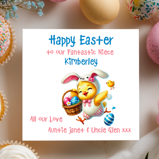 Easter card with cartoon chick in bunny costume holding a basket of eggs, surrounded by Easter eggs and cupcakes. Can be personalised with name, relation and Name of sender. 