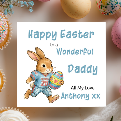Easter card with a bunny holding an egg to look like an American Football player , surrounded by Easter eggs and cupcakes. Can be personalised with name, relation andante of sender. 