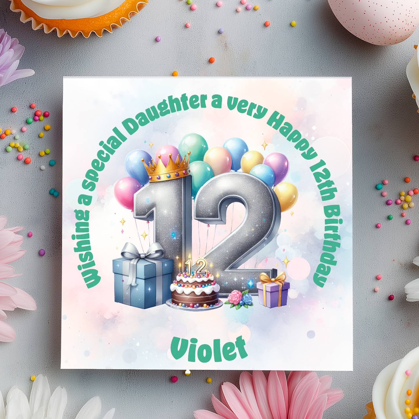 12th Birthday card with a number 12 ,colorful balloons, cake, and crown on a decorative background with flowers and candies.