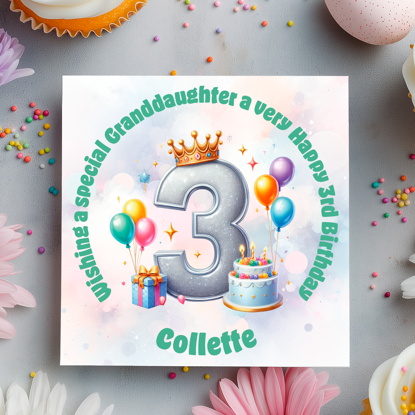 3rd Birthday card with a number 3,colorful balloons, cake, and crown on a decorative background with flowers and candies.